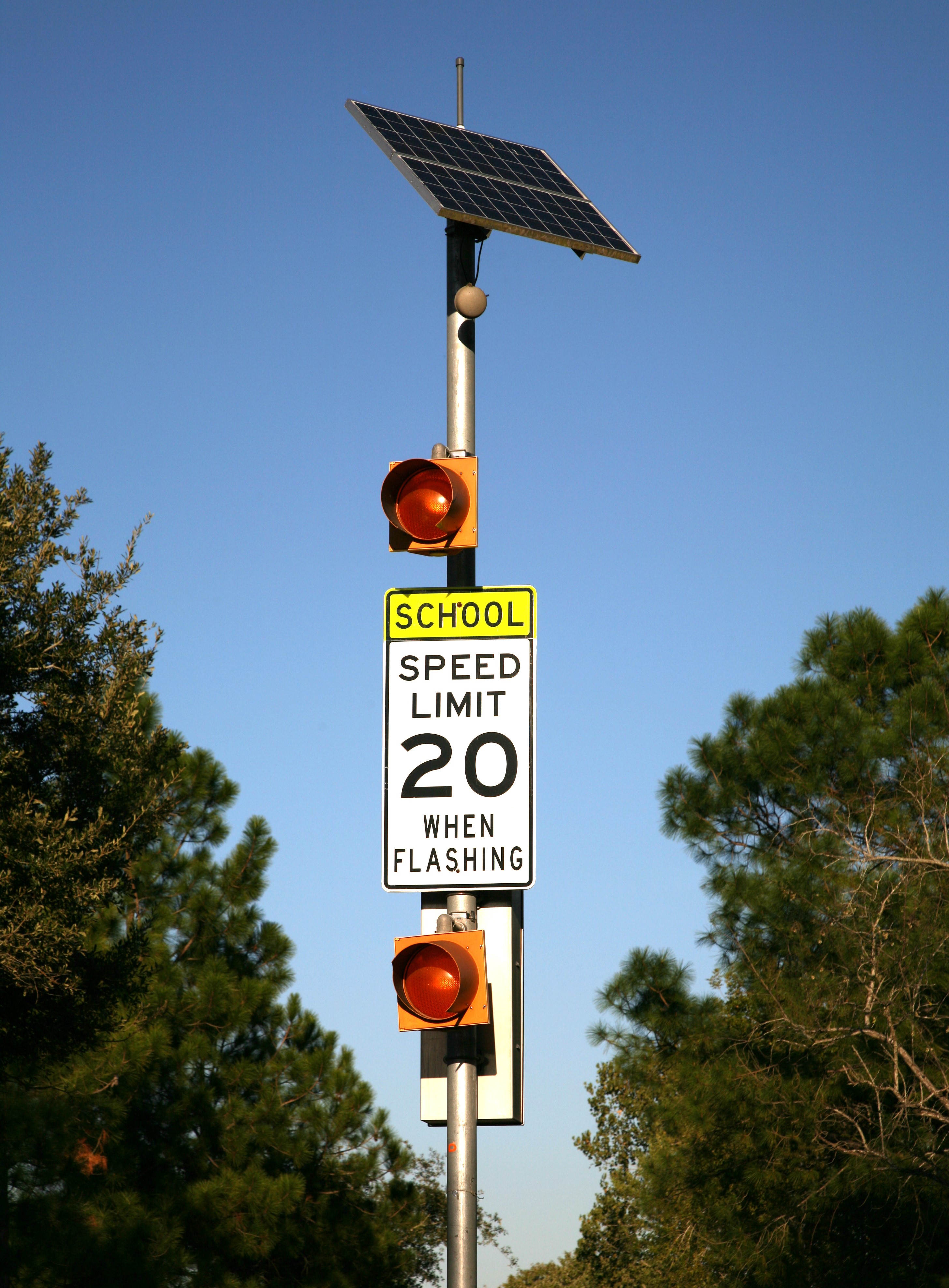 A flashing beacon mounted to a pole. 