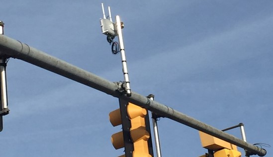 A roadside unit on a mast arm of a traffic signal.