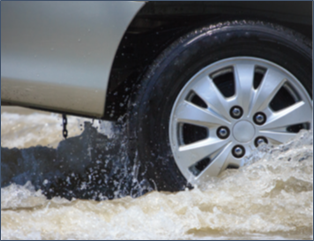 A vehicle wheel shown driving in flood-like conditions. 