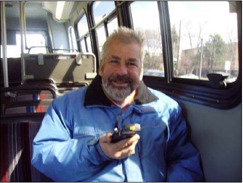 Man using the travel assistance app on a bus