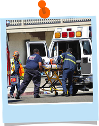 Medics moving a patient into an ambulance