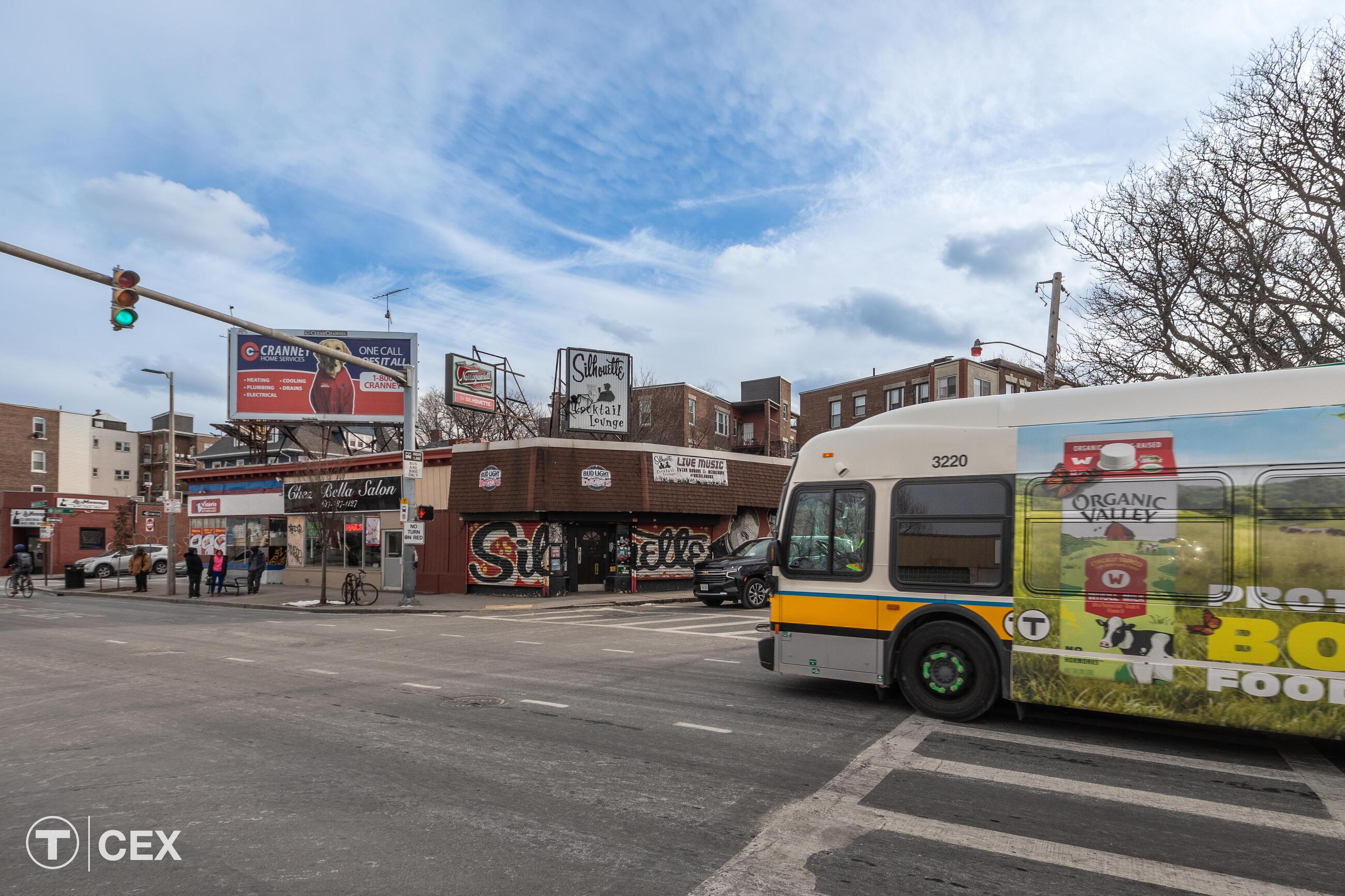Image of a bus going through an intersection with a green light