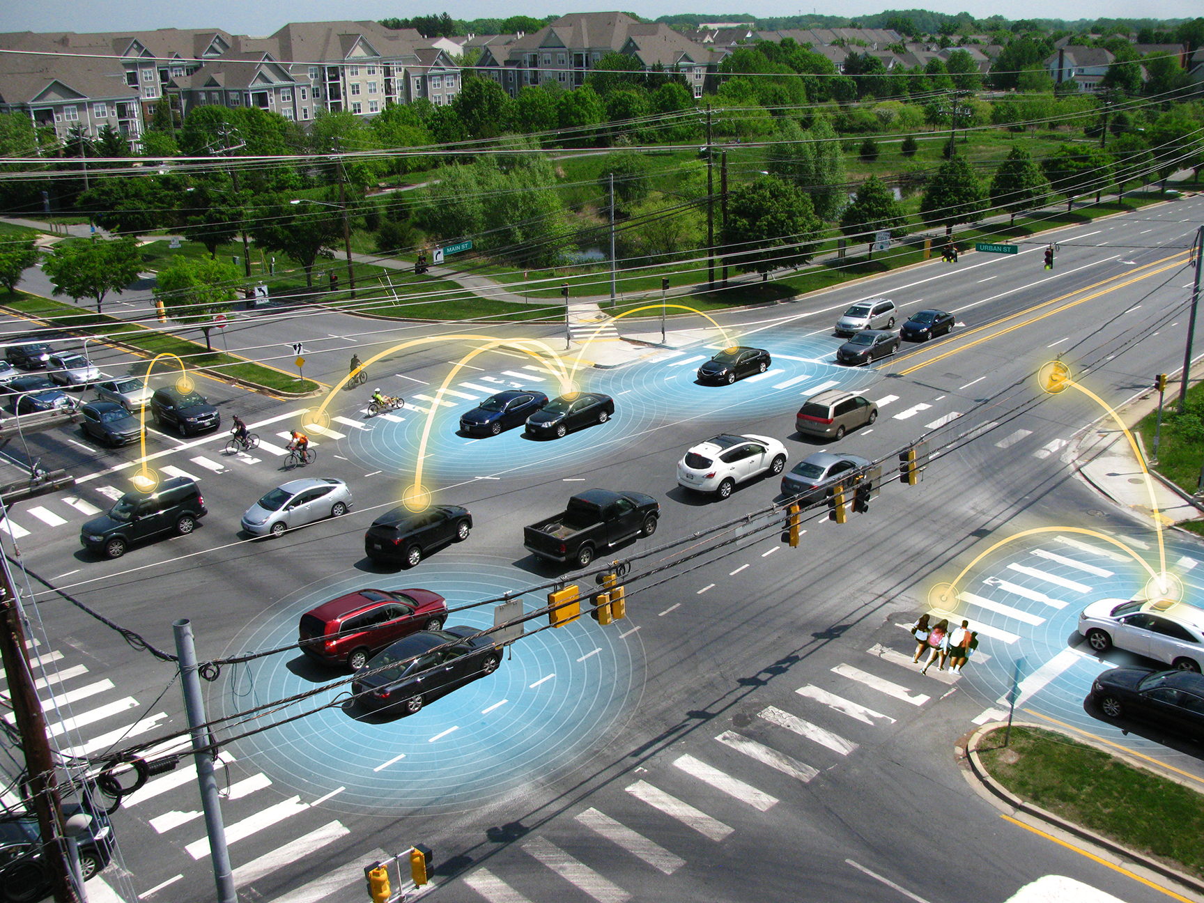 Photo diagram of cars moving through an intersection, with arcs of light connecting cars symbolizing V2x connectivity