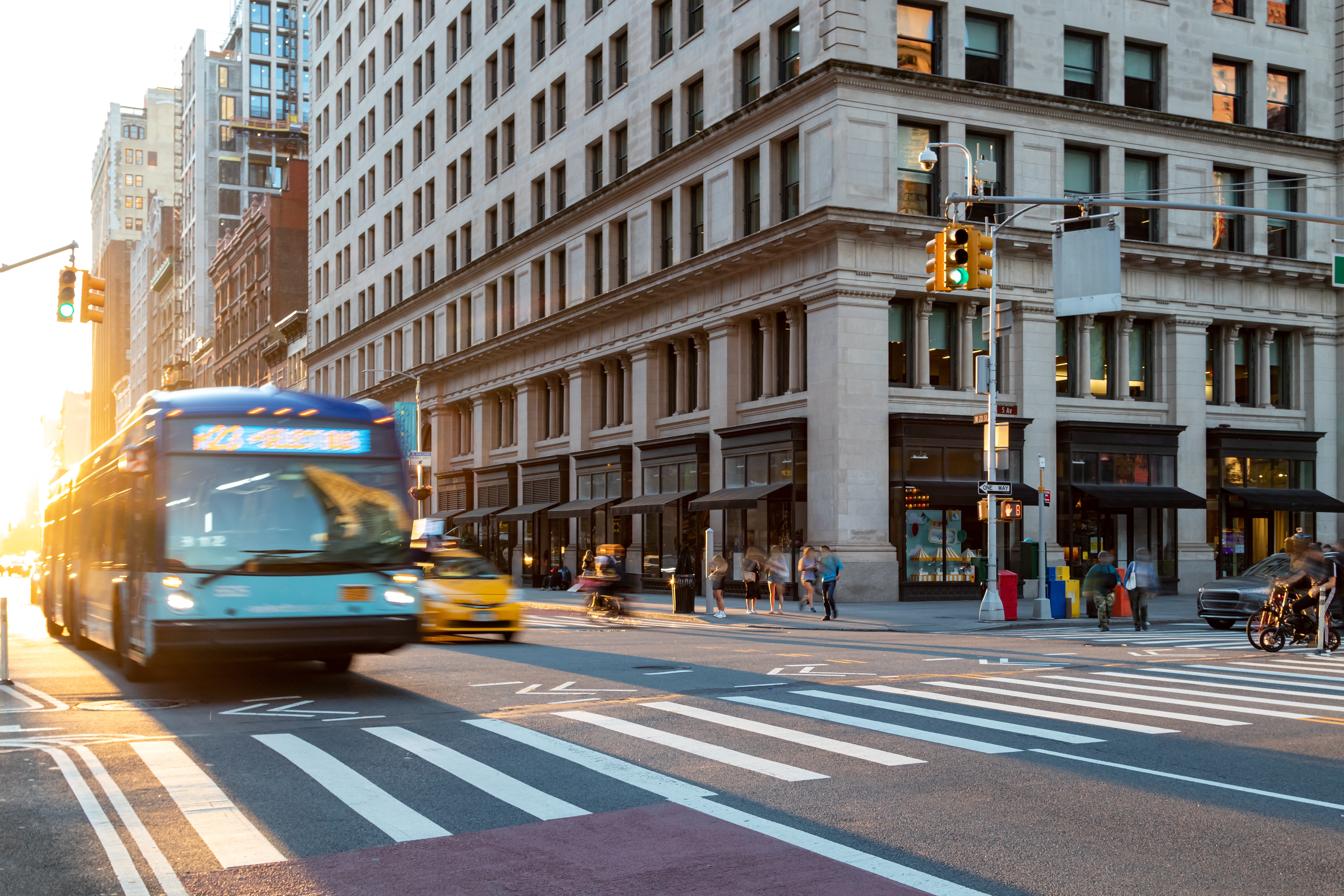Transit bus driving through a signalized intersection (Source: Shutterstock/Ryan DeBerardinis)