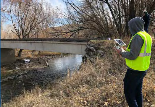 An inspector inspecting a bridge with a UAV