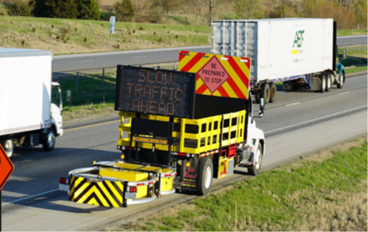 Queue truck along the side of a roadway used to alert drivers